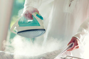 woman ironing a shirt with a rowenta iron